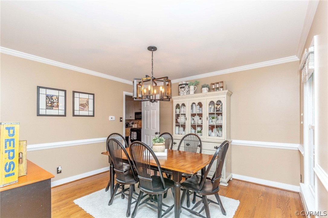 14302 Huntgate Woods Road Midlothian, VA 23112 - Photo 11 of 50 a view of a dining room with furniture and chandelier