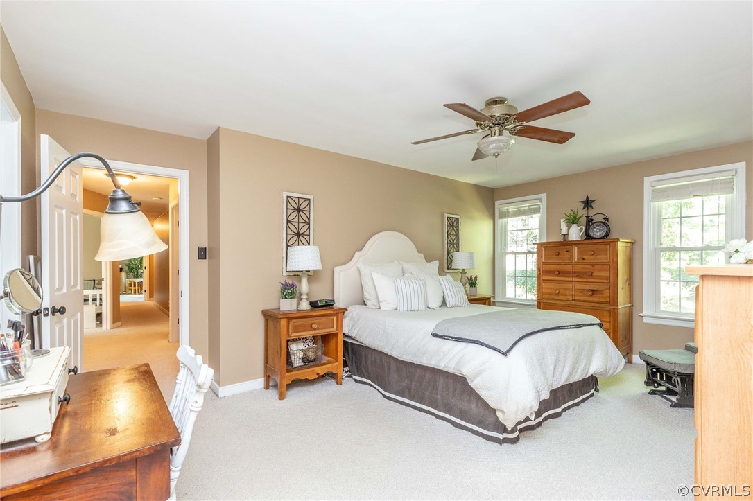 14302 Huntgate Woods Road Midlothian, VA 23112 - Photo 31 of 50 a bedroom with a bed and a chandelier