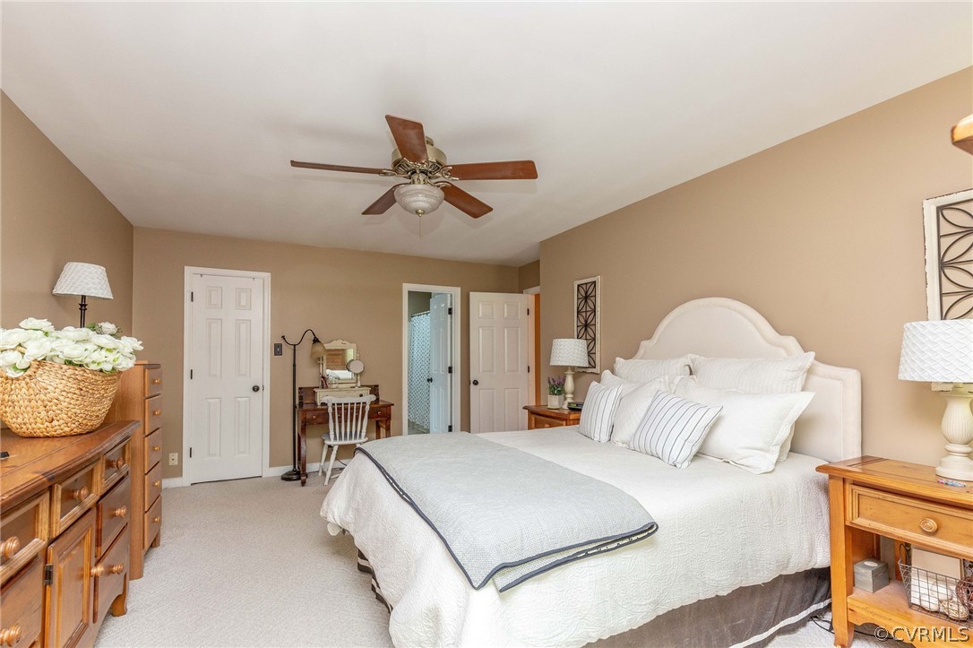 14302 Huntgate Woods Road Midlothian, VA 23112 - Photo 32 of 50 a spacious bedroom with a bed and a chandelier