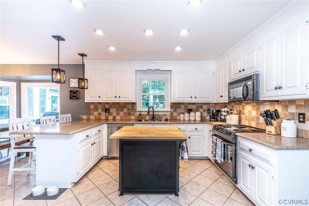 14302 Huntgate Woods Road Midlothian, VA 23112 - Photo 4 of 50 a kitchen with a sink stove top oven and cabinets