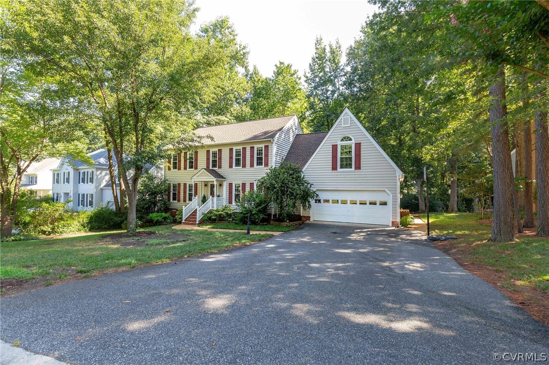 14302 Huntgate Woods Road Midlothian, VA 23112 - Photo 47 of 50 a front view of a house with a yard and garage