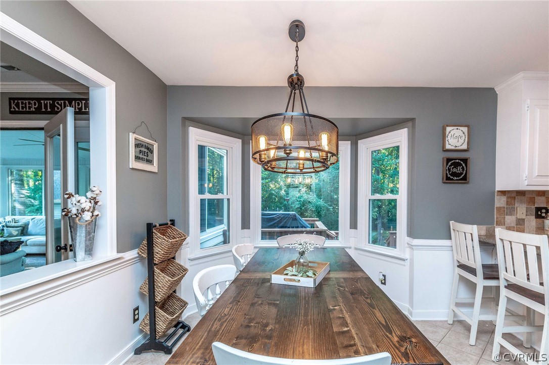 14302 Huntgate Woods Road Midlothian, VA 23112 - Photo 6 of 50 a view of a dining room and livingroom with furniture wooden floor a chandelier