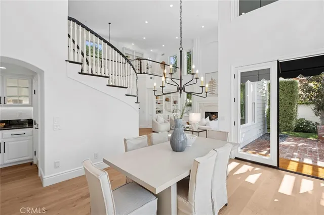 a view of a patio with couches potted plants and a large tree