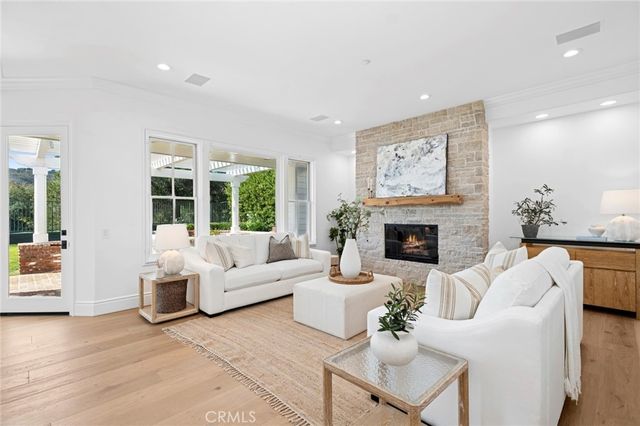 a living room with fireplace furniture and a large window