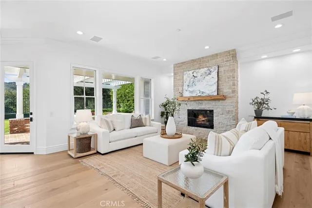 a living room with fireplace furniture and a large window