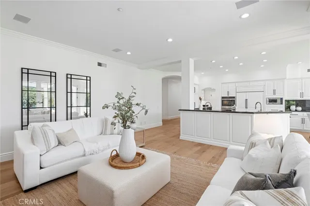 an open kitchen with granite countertop a sink and white cabinets