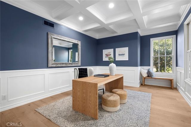 a bedroom with a bed a couch and large window