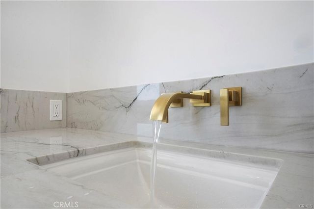 a bathroom with double vanity sink and a mirror