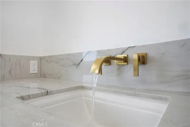 a bathroom with double vanity sink and a mirror