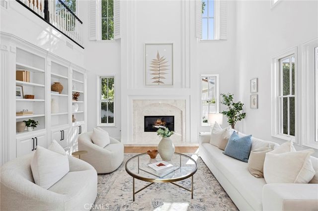 a living room with furniture a rug and a fireplace