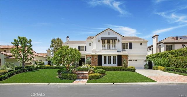 a front view of a house with a yard table and chairs