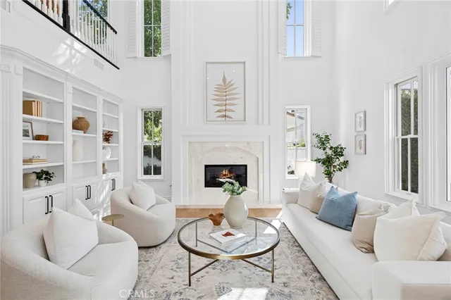 a living room with furniture a fireplace and a table