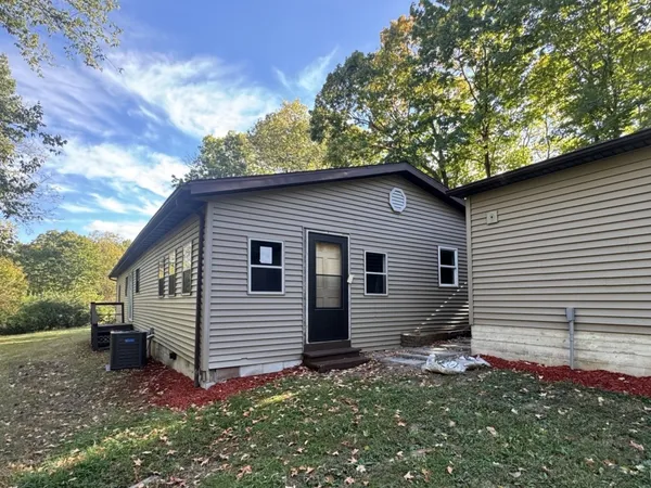 a backyard of a house with table and chairs