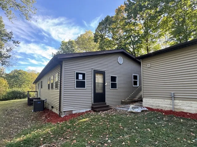 a backyard of a house with table and chairs