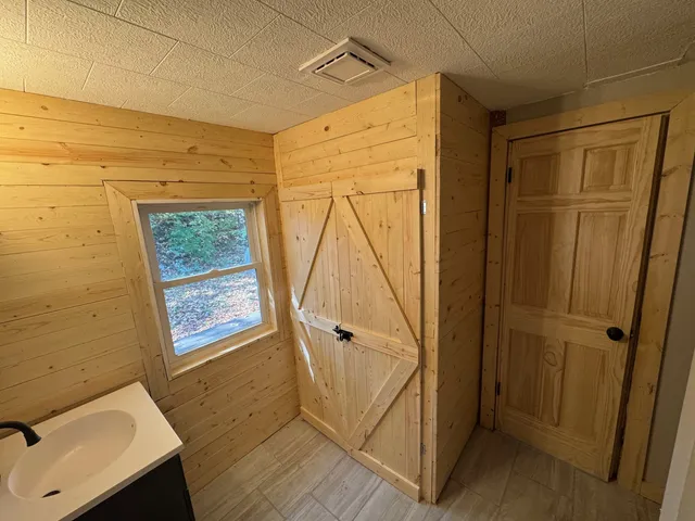 a bathroom with a sink toilet and mirror