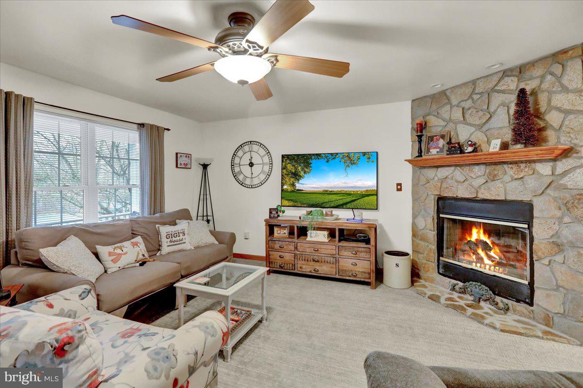 1060 Shelbourne Road Reading, PA 19606 - Photo 5 of 30 a living room with furniture a flat screen tv and a fireplace