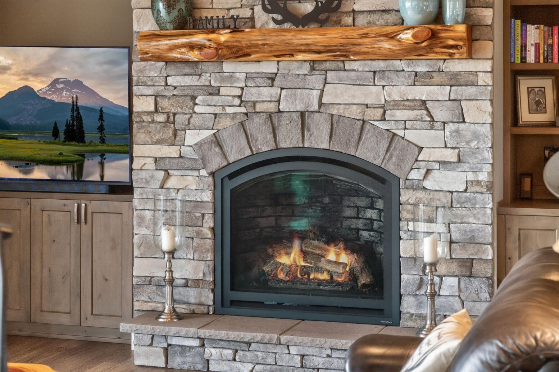 11620 Southwest Pixie Lane Culver, OR 97734 - Photo 17 of 53 a stone fireplace with a clock on it