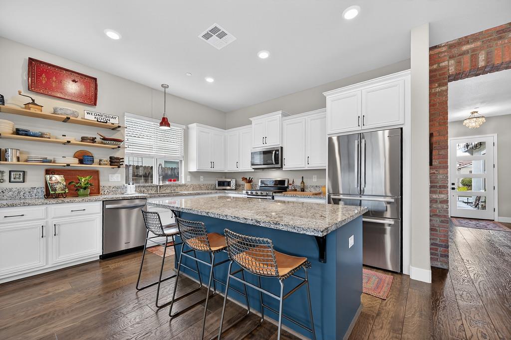 3900 Fenway Circle Rocklin, CA 95677 - Photo 20 of 57 Ample cupboard space complemented by modern floating shelves.