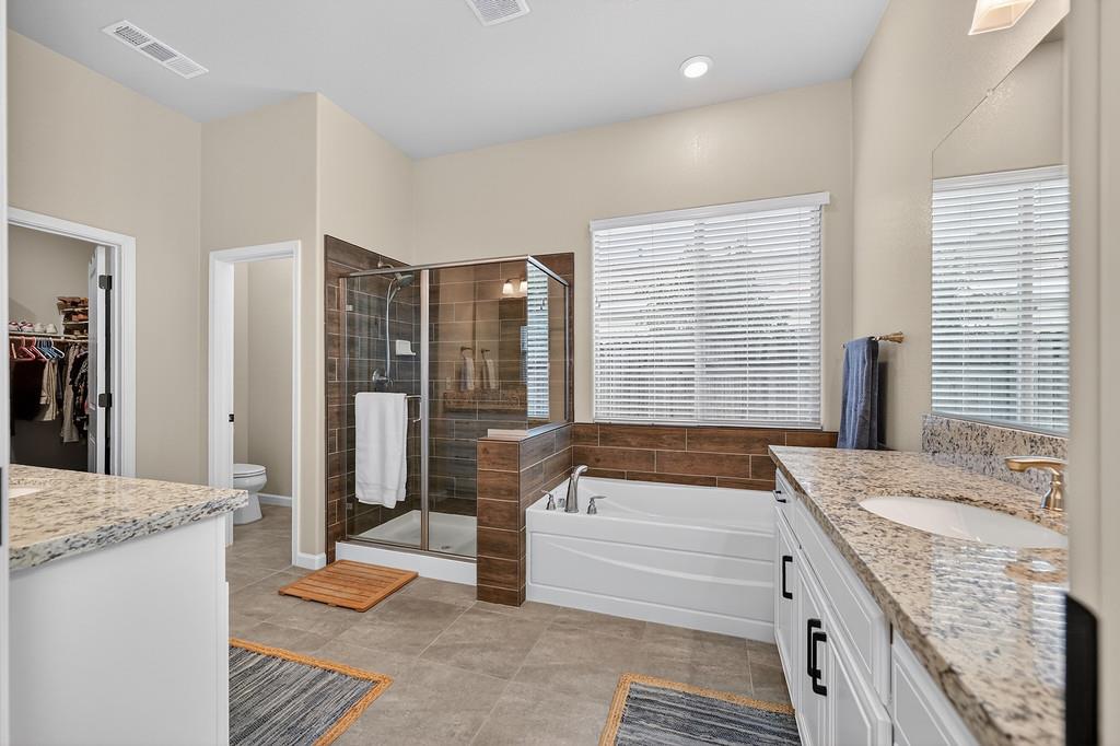 3900 Fenway Circle Rocklin, CA 95677 - Photo 41 of 57 Primary bathroom offers walk in shower with separate tub, two sinks and large walk in closet.