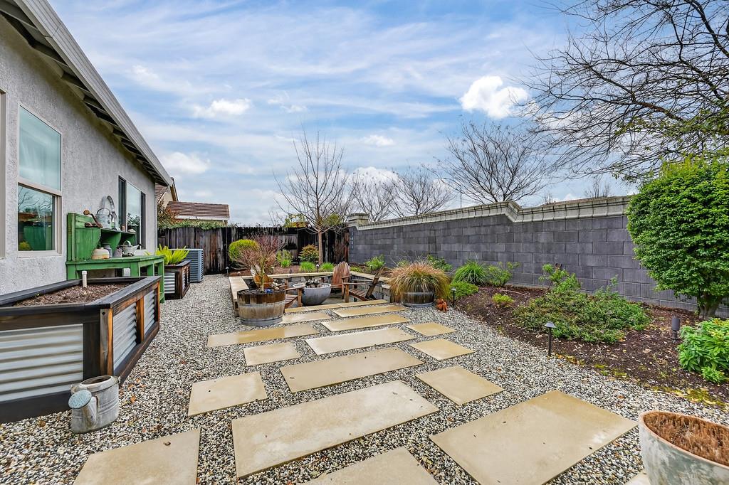 3900 Fenway Circle Rocklin, CA 95677 - Photo 48 of 57 Two raised garden beds with irrigation, concrete steps lead to a sunken area where you can have your own fire pit hangs!