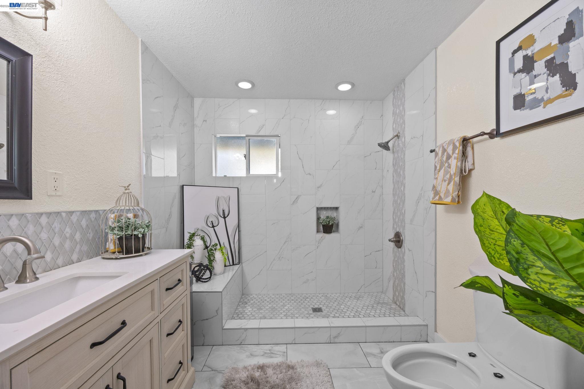 2245 Sol Street Castro Valley, CA 94578 - Photo 26 of 36 a bathroom with a granite countertop sink a toilet and shower