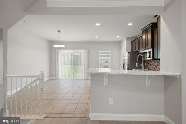 a kitchen with stainless steel appliances a stove sink and microwave