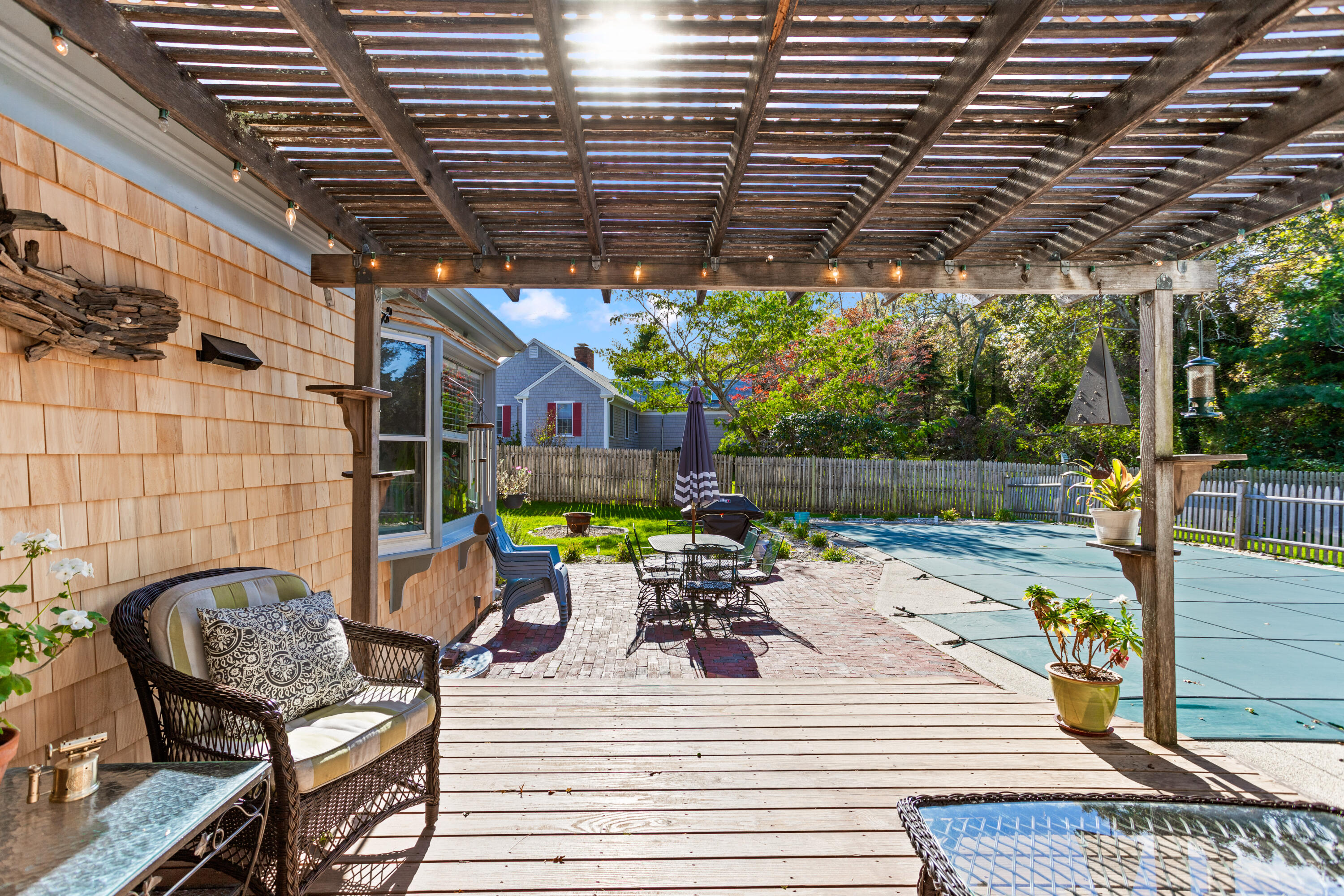 85 Stonehedge Road Barnstable, MA 02630 - Photo 9 of 41 a view of a roof deck with table and chairs barbeque with wooden floor and fence
