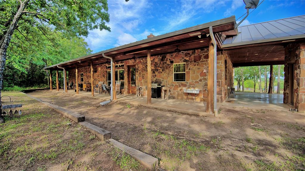 4509 Lazy E Road St. Jo, TX 76265 - Photo 23 of 39 a view of a house with backyard and porch