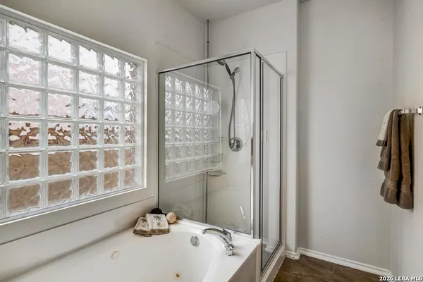 a bathroom with a tub and a window