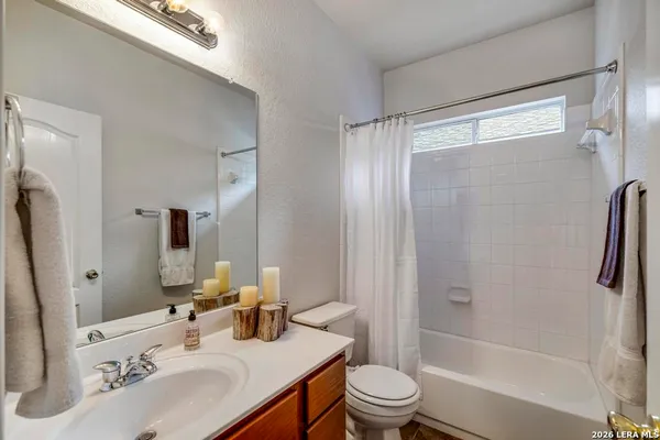 a bathroom with a sink toilet tub and shower