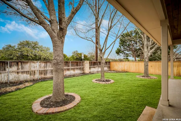 a swimming pool with lots of tress in front of it