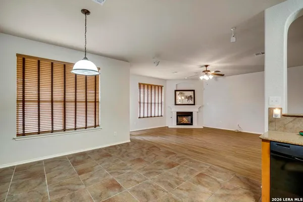 a view of an empty room with a fireplace and a window