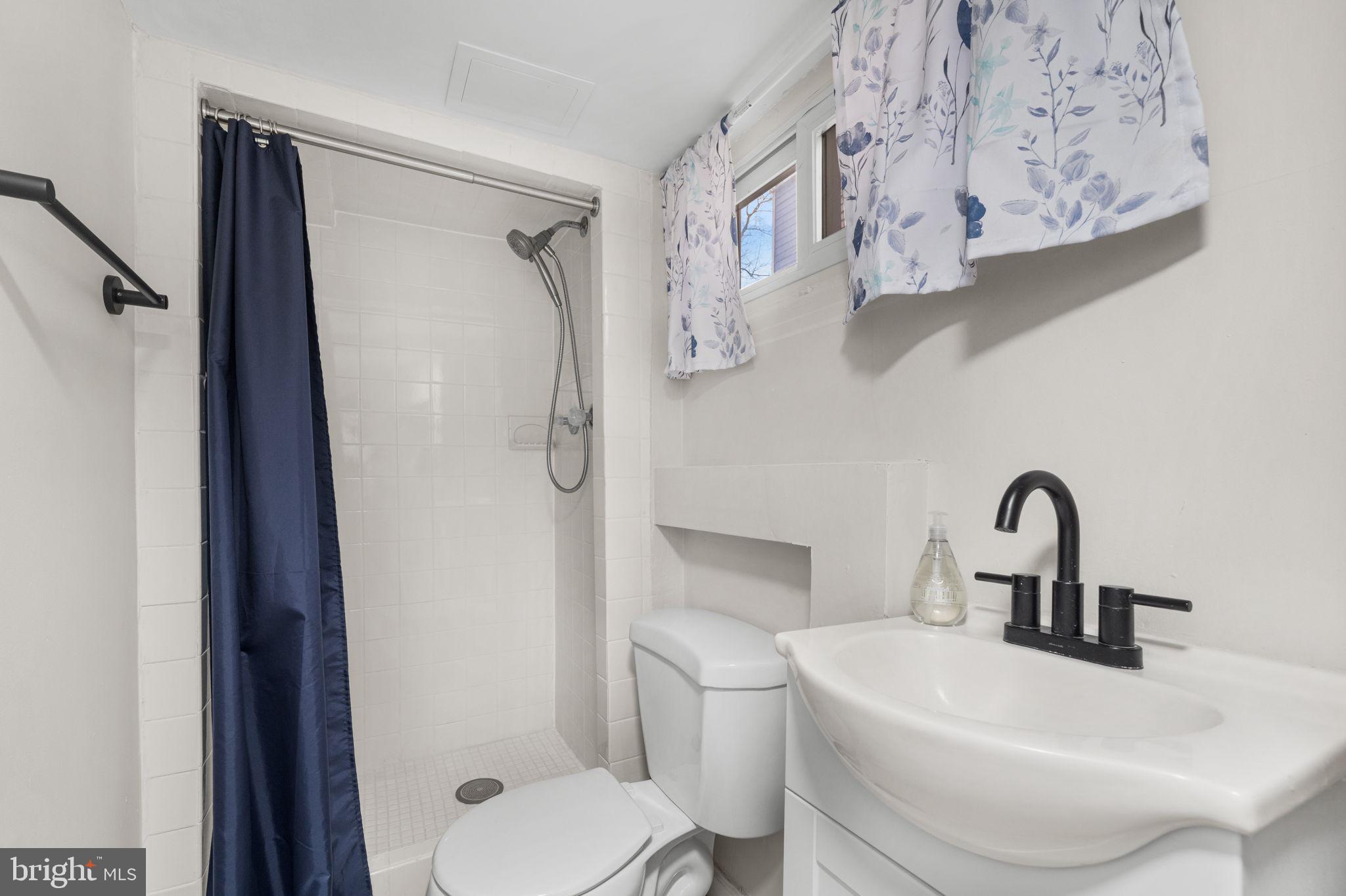 1227 Talbert Street Southeast Washington, DC 20020 - Photo 51 of 64 a bathroom with a toilet sink and shower curtain