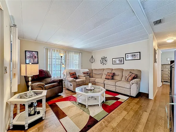 a living room with furniture a rug and a window