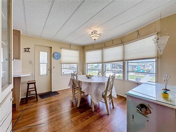a view of a dining room with furniture window and wooden floor