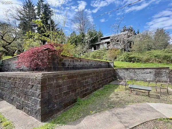 a view of a bench with wooden fence