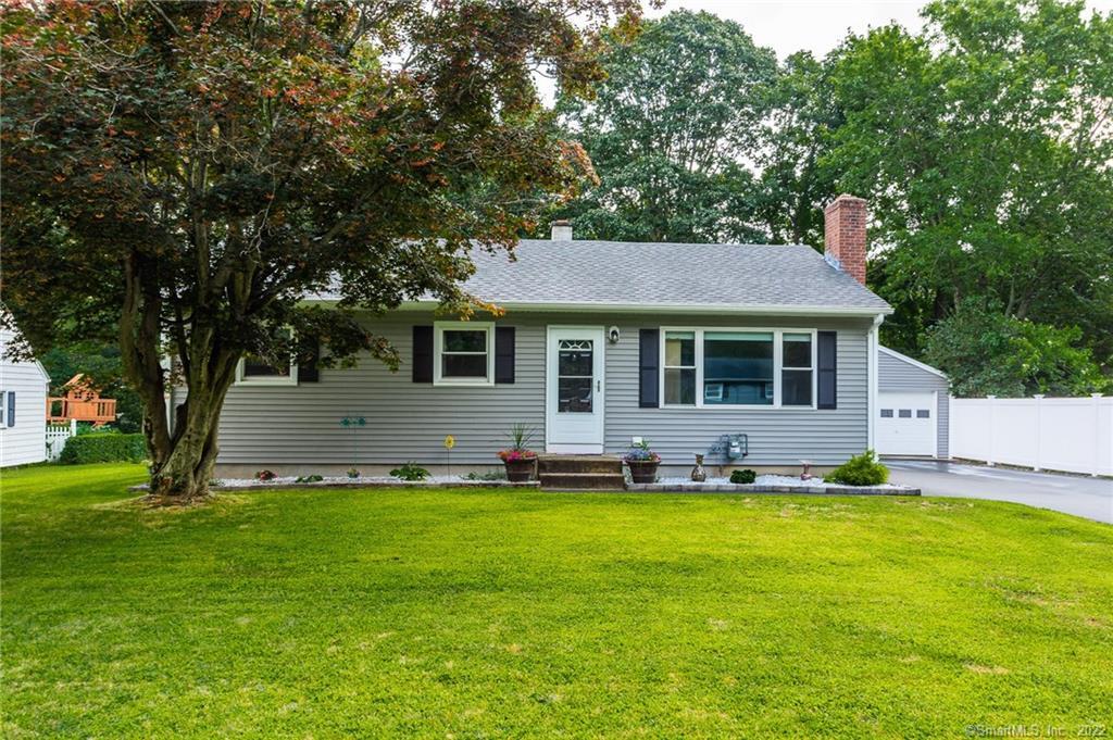 21 Manor Road Montville, CT 06370 - Photo 1 of 1 a front view of a house with a garden and tree