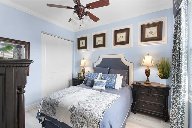 a bedroom with a bed and a lamp on the dresser