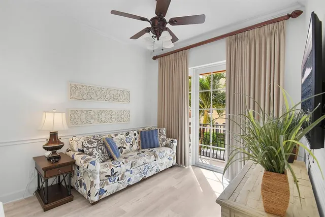 a living room with furniture and a potted plant