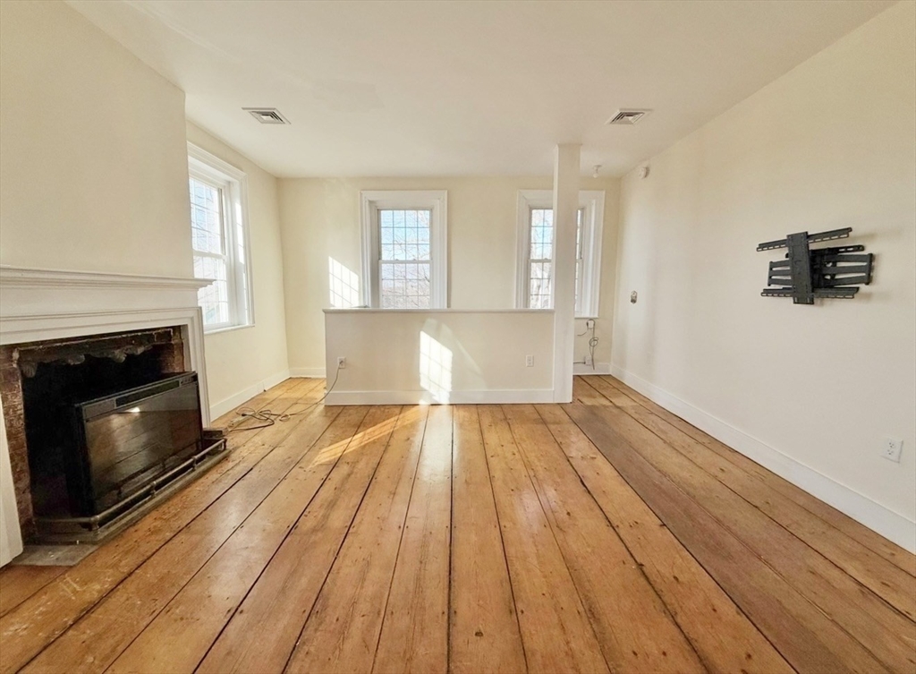 278 East Main Street Plainfield, MA 01070 - Photo 14 of 33 a view of wooden floor and a fireplace in a room