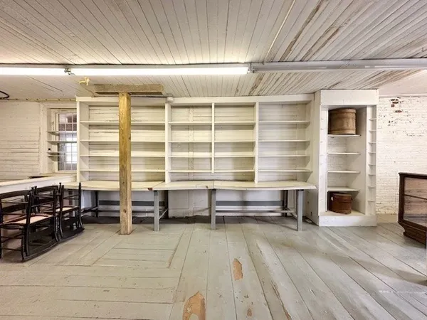 a view of a room with furniture and windows