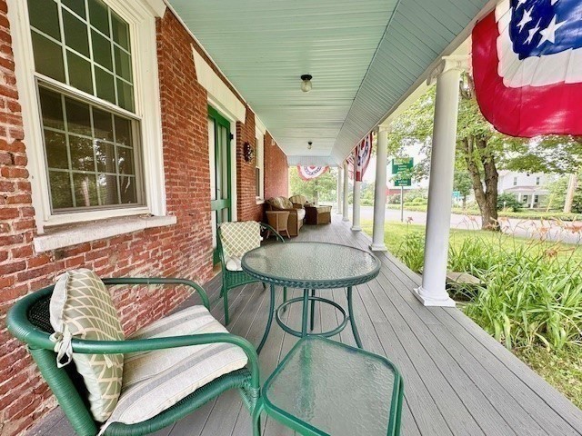 278 East Main Street Plainfield, MA 01070 - Photo 31 of 33 a balcony with table and chairs with wooden floor and plants