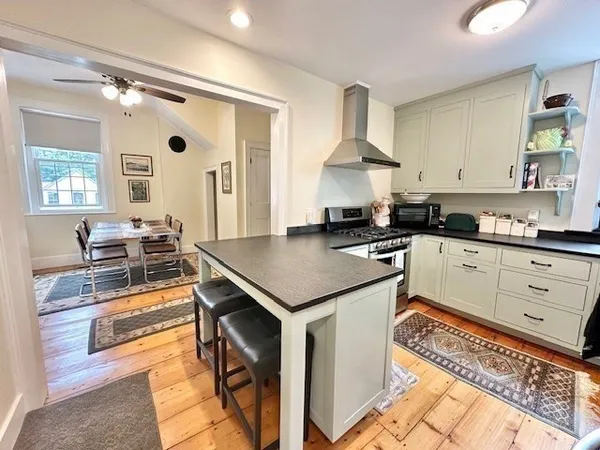 a kitchen with a stove cabinets and a window