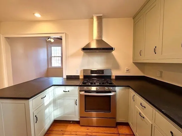 a kitchen with granite countertop a stove and a sink