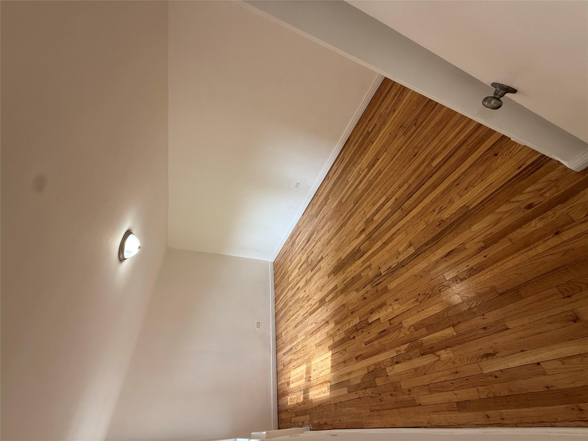 67-25 Clyde Street, Unit 5D Queens, NY 11375 - Photo 5 of 6 a view of empty room with wooden floor