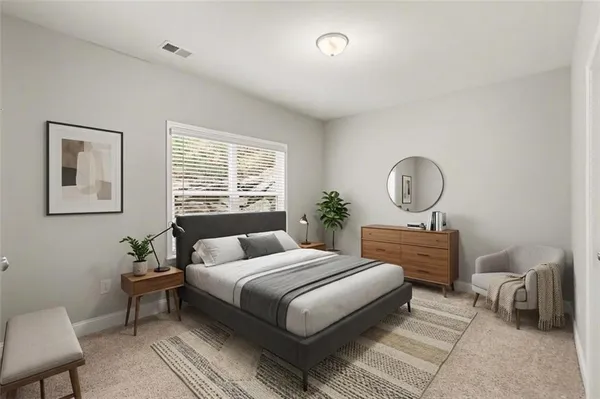 a bedroom with a large bed and a window