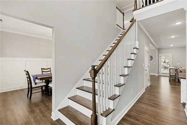 a view of entryway and dining room with wooden floor