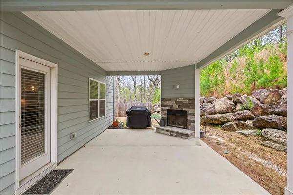 a view of a porch with furniture and garden