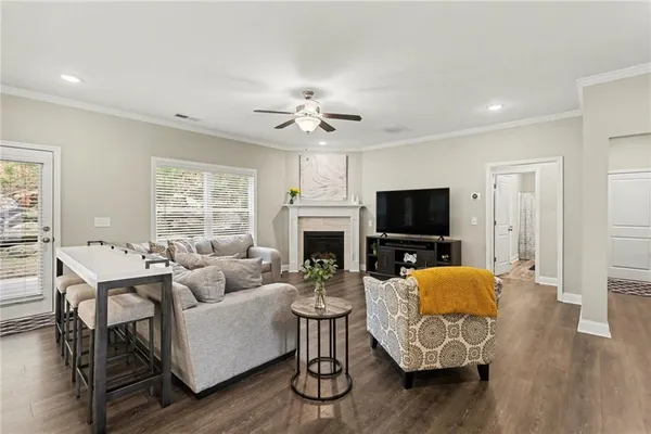 a living room with furniture a flat screen tv and a fireplace
