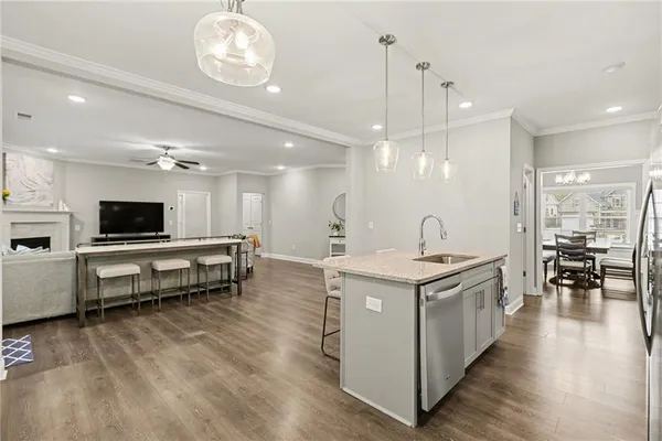 a kitchen with kitchen island a sink counter top space and stainless steel appliances